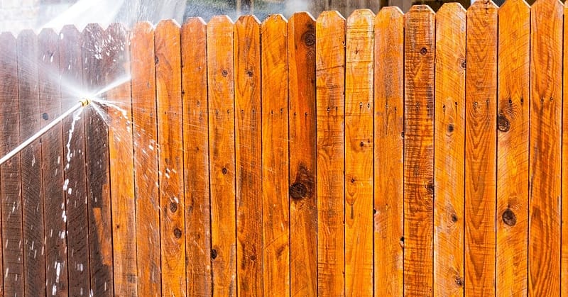Fence being soft washed