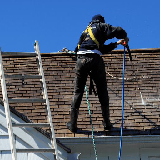 man washing a roof